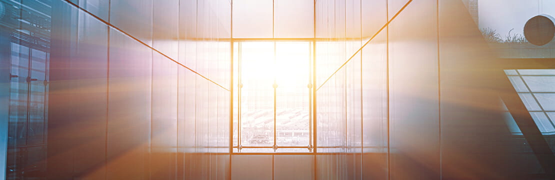 Sunlight flooding a modern glass atrium, symbolizing a sudden wealth event and the needed for thoughtful legacy planning.